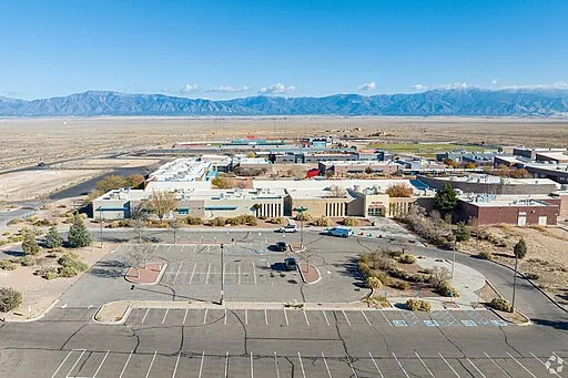 Aerial view of industrial buildings and desert landscape.