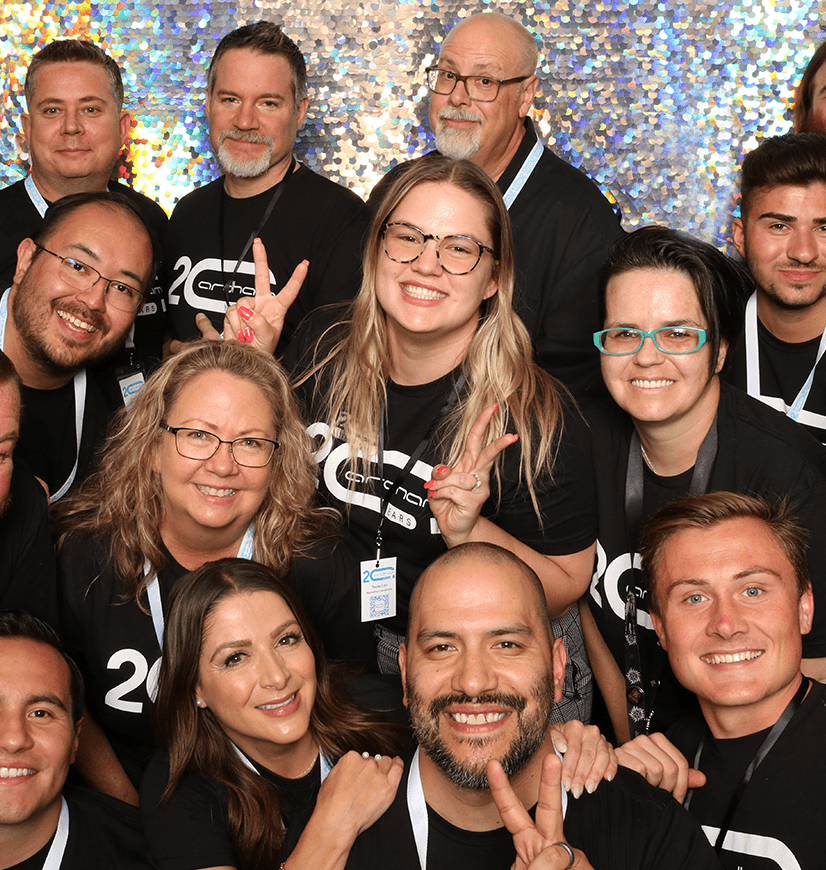 Smiling group celebrating 20th anniversary