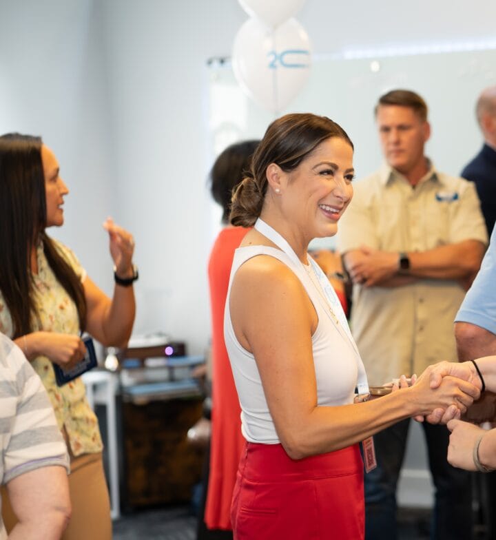 Woman shaking hands at networking event