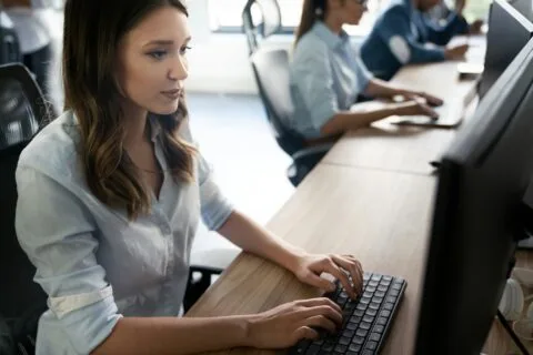 Office workers typing on desktop computers