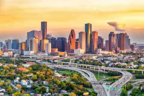 Houston skyline and freeway interchange glowing at sunset