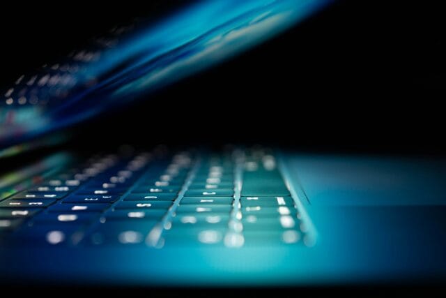 Close-up of illuminated laptop keyboard in dark